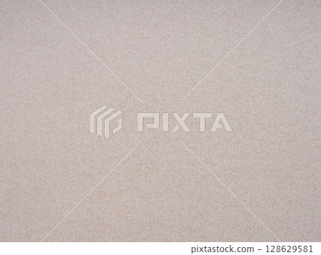 A close-up view reveals the intricate details and subtle elegance of a beige paper canvas A close-up view reveals the intricate details and subtle elegance of a beige paper canvas 128629581