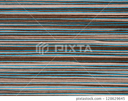 Designer's veneer surface with vibrant teal and rich brown stripes creating a bold contrast 128629645