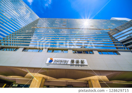 Yokohama cityscape in Japan in July. Extremely hot...SOTETSU Yokohama Station and sunlight reflected on the windows. 128629715