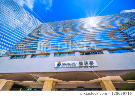 Yokohama cityscape in Japan in July. Extremely hot...SOTETSU Yokohama Station and sunlight reflected on the windows. 128629716