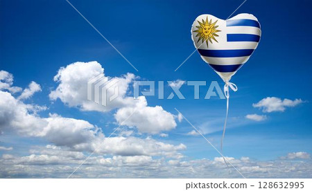 Uruguay flag heart shaped balloon and blue sky 128632995