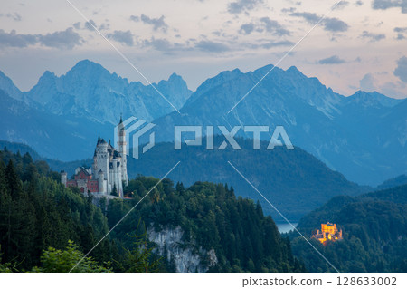Neuschwanstein Castle at Dusk Surrounded by Rocky Mountains Neuschwanstein Castle at Dusk Surrounded by Rocky Mountains 128633002