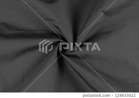 Photo of black fabric on black. Crumpled black fabric. Isolated photo of fabric. Photo of black fabric on black. Crumpled black fabric. Isolated photo of fabric. 128633022