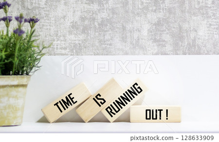 Wooden blocks with the text TIME IS RUNNING OUT on a beautiful background 128633909