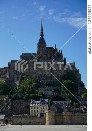 Spectacular view of Mont Saint-Michel and blue sky at low tide Spectacular view of Mont Saint-Michel and blue sky at low tide 128633935