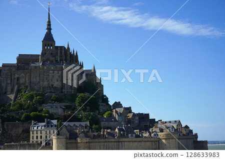 Mont Saint-Michel's ramparts and abbey against the blue sky Mont Saint-Michel's ramparts and abbey against the blue sky 128633983