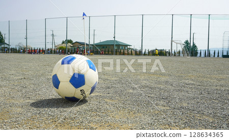 Soccer ball rolling in the schoolyard 128634365