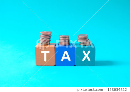 Coins stack standing,Word Tax write on wooden blocks. Coins stack standing,Word Tax write on wooden blocks. 128634812