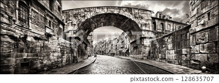 Ancient Stone Archway Historic Street Cityscape Urban Architecture Old Town Building grey wall road 128635707