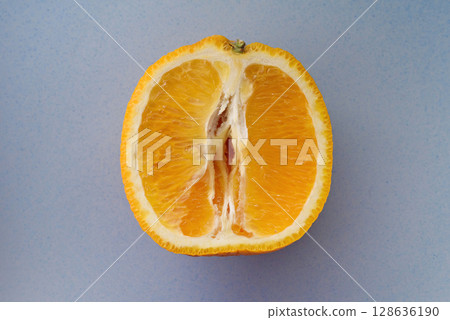 Photo of juicy halved orange. Citrus fruit macro photo like female vulva 128636190