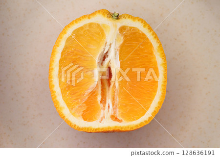 Photo of juicy halved orange. Citrus fruit macro photo 128636191
