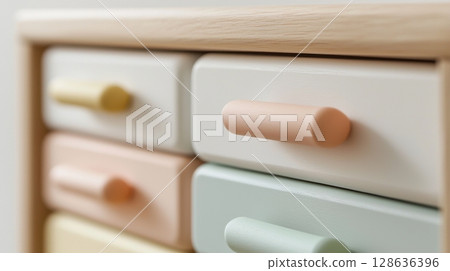 Close-up of pastel-colored drawers in modern wooden baby dresser Close-up of pastel-colored drawers in modern wooden baby dresser 128636396