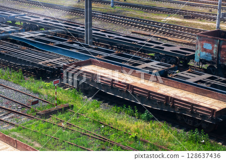 A train is on the tracks with a large empty wagon, awaiting instructions A train is on the tracks with a large empty wagon, awaiting instructions 128637436