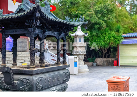 Hainan Island, Sanya: Nanshan Buddhist Center. View of the incense burner in front of the Temple Hainan Island, Sanya: Nanshan Buddhist Center. View of the incense burner in front of the Temple 128637580