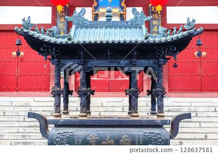 Hainan Island, Sanya: Nanshan Buddhist Center. View of the incense burner in front of the Temple Hainan Island, Sanya: Nanshan Buddhist Center. View of the incense burner in front of the Temple 128637581