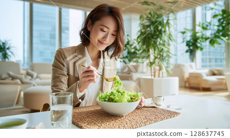 Healthy woman eating salad in the office break room 128637745