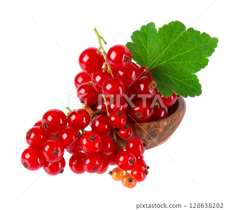 Red currant isolated on white background. Redcurrant or Ribes rubrum ripe berries with green leaves in wooden bowl. Red currant isolated on white background. Redcurrant or Ribes rubrum ripe berries with green leaves in wooden bowl. 128638202