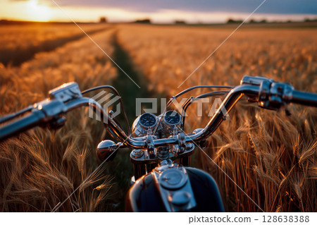 A motorcycle is in the foreground of a field of wheat A motorcycle is in the foreground of a field of wheat 128638388