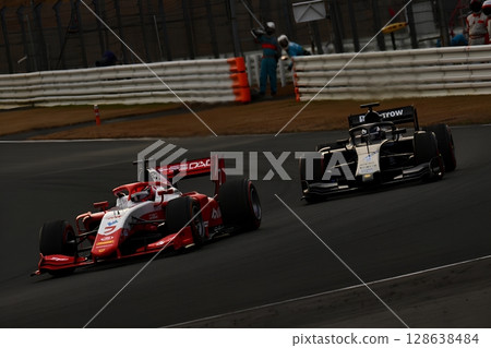 Close-up of two formula race cars dueling on track, high-speed motorsport competition 128638484