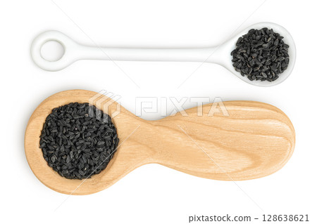 Nigella sativa or Black cumin in wooden and ceramic spoon isolated on white background. Top view. Flat lay. Nigella sativa or Black cumin in wooden and ceramic spoon isolated on white background. Top view. Flat lay. 128638621