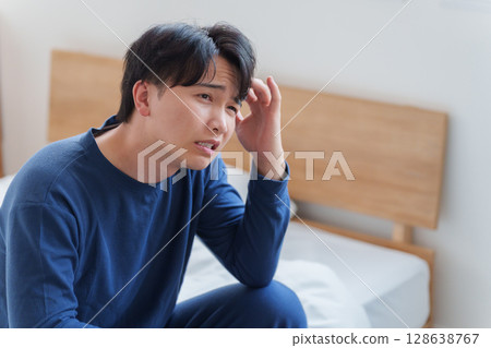 Man thinking in bed Man thinking in bed 128638767