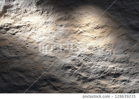 Rock surface texture illuminated by light | Stone background material with a thick and natural texture 128639235