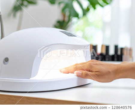 Sparkle on your fingertips: gel nails made possible with the latest LED lights 128640576