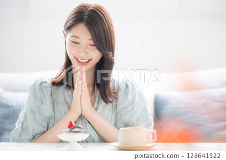 Autumn is the season for appetites. A woman eating sweet desserts with a smile. She'll eat the desserts separately. Autumn is the season for appetites. A woman eating sweet desserts with a smile. She'll eat the desserts separately. 128641522