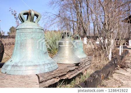 A beautiful Rustic Vintage Bell Collection displayed harmoniously in the embrace of Nature A beautiful Rustic Vintage Bell Collection displayed harmoniously in the embrace of Nature 128641922