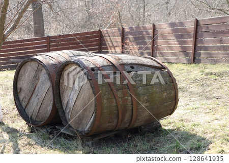 Wooden Barrels Beautifully Placed in a Scenic Nature Setting Surrounded by Greenery and Life Wooden Barrels Beautifully Placed in a Scenic Nature Setting Surrounded by Greenery and Life 128641935