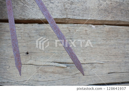 Image depicting Rusty Nails on a Wooden Surface showcasing distress and aged textures Image depicting Rusty Nails on a Wooden Surface showcasing distress and aged textures 128641937
