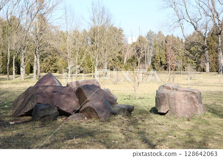 A Scenic View of Large Rocky Boulders Set Against a Lush Green Meadow Background A Scenic View of Large Rocky Boulders Set Against a Lush Green Meadow Background 128642063