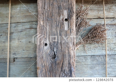 A Rustic Wooden Plank beautifully adorned with a delightful arrangement of Dried Herbs Decoration 128642078