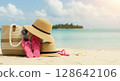 Straw hat standing on the beach (enjoying summer vacation) 128642106