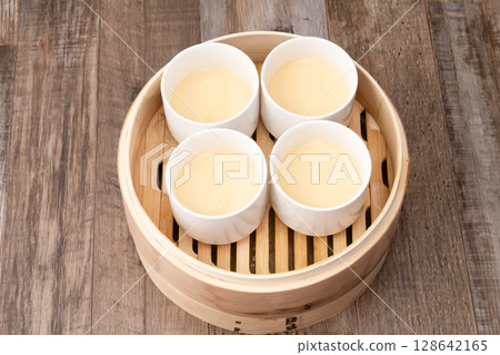 Steamed pudding in a bamboo steamer Steamed pudding Steamed pudding in a bamboo steamer Steamed pudding 128642165