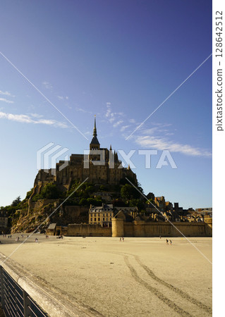 Mont Saint-Michel and the tidal flats in the setting sun 128642512