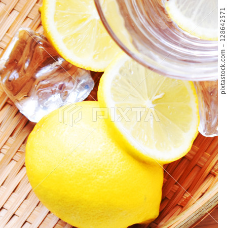 A colander filled with lemon and ice, packed with Vitamin C perfect for the hot summer 128642571