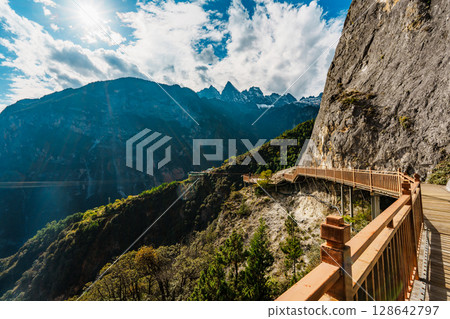Sunlit mountain walkway overlooking deep gorge in Balagezong, Shangri-La, China Sunlit mountain walkway overlooking deep gorge in Balagezong, Shangri-La, China 128642797