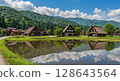 Shirakawa-go Gassho-zukuri style houses reflected in the rice fields in summer 128643564