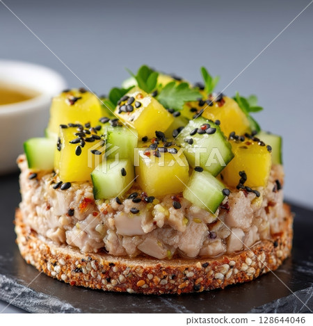 Gourmet Smoked Eel Mousse on Crisp Nori Cracker with Apple Gel and Pickled Cucumber Garnish and Black Sesame Seeds 128644046