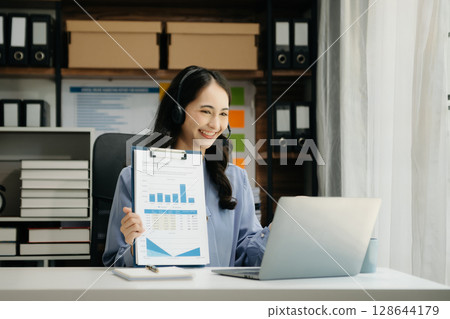 Asian business woman have the joy of talking on the smartphone, tablet and laptop video call on the modern office Asian business woman have the joy of talking on the smartphone, tablet and laptop video call on the modern office 128644179