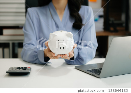 woman hand coins with piggy bank. business finance saving and investment concept. 128644183