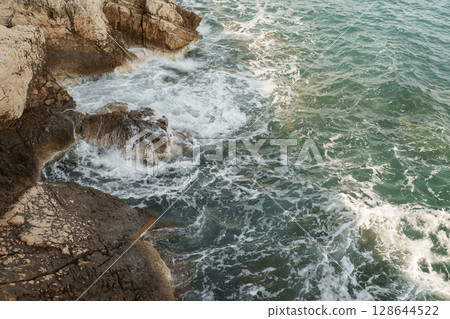 Fresnch Riviera cliffs with sea waves crushing on them 128644522