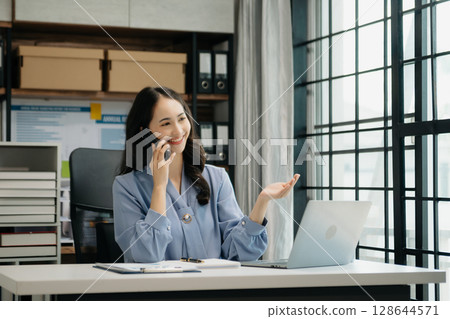 Asian business woman have the joy of talking on the smartphone, tablet and laptop video call on the modern office 128644571