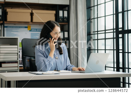Asian business woman have the joy of talking on the smartphone, tablet and laptop video call on the modern office Asian business woman have the joy of talking on the smartphone, tablet and laptop video call on the modern office 128644572