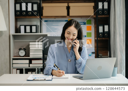 Asian business woman have the joy of talking on the smartphone, tablet and laptop video call on the modern office Asian business woman have the joy of talking on the smartphone, tablet and laptop video call on the modern office 128644573