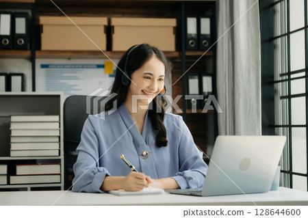 Asian business woman have the joy of talking on the smartphone, tablet and laptop video call on the modern office 128644600