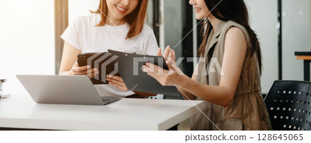 Portrait of success business people working together in office. Couple teamwork startup concept 128645065