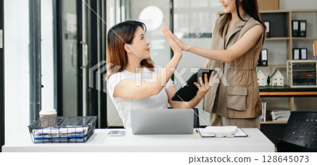 Portrait of success business people working together in office. Couple teamwork startup concept 128645073