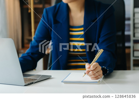 Business woman hand using laptop, tablet and smartphone in office. Digital marketing media mobile app and discussing plan new start up project. 128645836